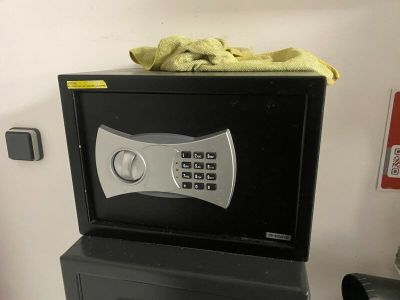 a small black safe box on top of a black filing cabinet