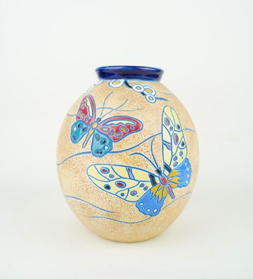 a vase with a butterfly design on it on a white background