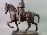 a bronze statue of a man riding a horse