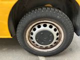 a close up of a tire on a yellow bus