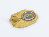 gold plated compass on a white background with a picture of a man