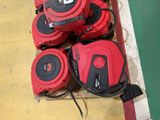 four red and black vacuums sitting on the ground