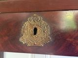 a close up of a brass plate on a wooden table