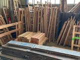 a large pile of wooden planks in a warehouse
