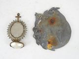 two pieces of jewelry that are sitting on a table