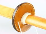 a close up of a wooden object with a thread spool attached to it