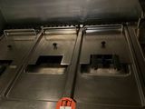 stainless steel counter top with three burners and a red tag on it