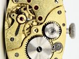an image of a close up of a watch face with gears on it
