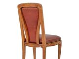 a wooden chair with a red leather seat on a white background