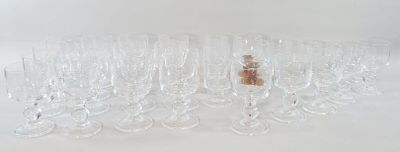 many empty wine glasses lined up on a white surface
