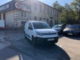 a white van that is parked in front of a building