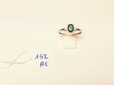 a ring with a green stone on it and a price tag