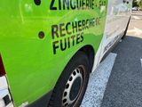a green and white van parked on the side of the road