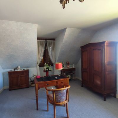 an image of a bedroom with a desk and a chair