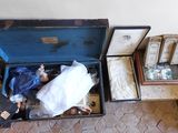 an open suitcase with a doll inside of it on the floor