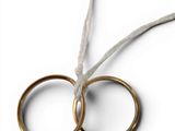 two pairs of gold wedding rings tied to a string