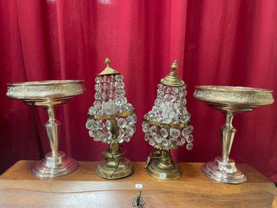 three glass vases sitting on top of a wooden table next to a red curtain