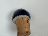 a wine bottle with a cork stopper attached to it