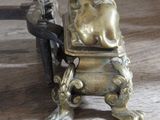 a statue of a woman sitting on a chair next to a candle