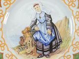 a plate with a picture of a woman in a blue dress