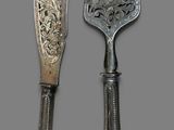 two forks and a knife on a gray background