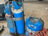 a man standing next to a blue and white gas tank