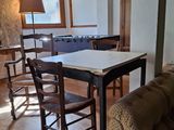 a living room with a couch, table and chairs in it