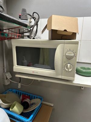 a microwave sitting on a counter in a small kitchen