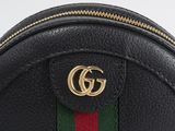 a close up of a black leather bag with a green, red and green stripe