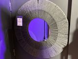 a round mirror hanging on a wall in a room