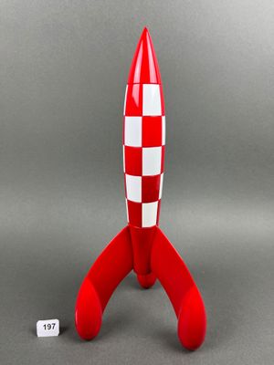 an image of a red and white toy rocket sitting on top of a table
