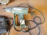 a picture of a corded blow dryer and other items on a table