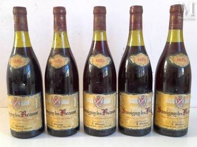 six bottles of wine are lined up on a table