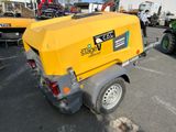 a small yellow machine that is parked in the parking lot