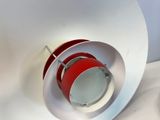 a red and white light that is on a white surface