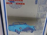 an image of a framed picture of a blue car on a white wall