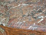 a marble top table with a drawer underneath it