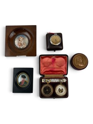 four different types of clocks in a case on a white surface