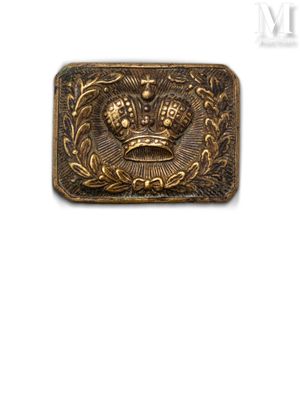 a close up of a metal belt buckle with a crown on it