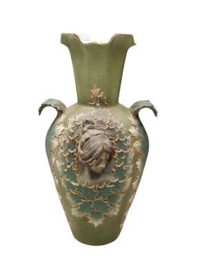 a green vase with a face on it on a white background