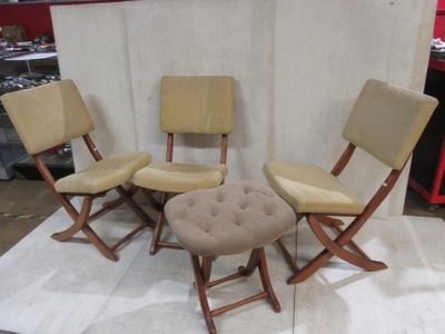 three chairs and a stool are sitting on a rug in front of a white backdrop