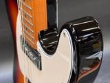 a close up of an electric guitar with a black body