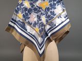 a blue and white floral print scarf on a mannequin head