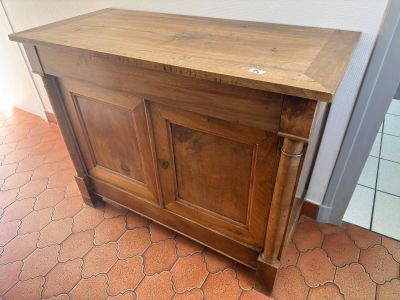a small wooden cabinet with a door on top of it