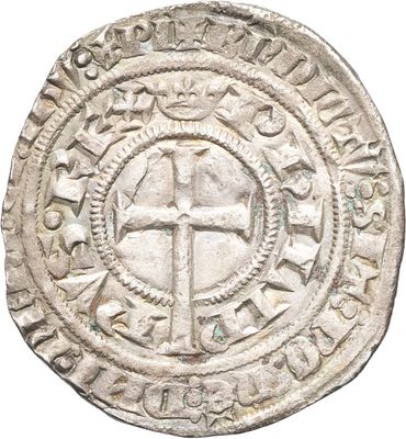 une vieille pièce d'argent ornée d'une croix