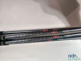 a close up of two fishing rods on a white surface