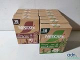 four boxes of nescafe coffee sitting on top of a counter