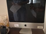 a computer monitor sitting on a desk next to a cup of coffee