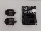 two black pedals that are on a white surface