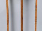 a wooden easel with a wooden handle on a gray background